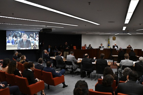 epa12166873 Mauro Cid (on screen), former secretary of former Brazilian President Jair Bolsonaro, participates in the interrogation session before the Supreme Court in Brasilia, Brazil, 09 June 2025.  ...