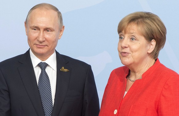 Russian President Vladimir Putin is greeted by German Chancellor Angela Merkel at the official welcoming ceremony at the G20 summit Friday, July 7, 2017 in Hamburg, Germany. (Remiorz/The Canadian Pres ...