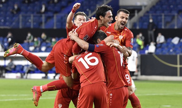 North Macedonia's Goran Pandev, right, is celebrated by his teammates after scoring his side's first goal during the World Cup 2022 group J qualifying soccer match between Germany and North ...