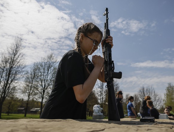 epa10594281 &#039;Yunarmiya&#039; (Young Army) All-Russia National Military Patriotic Social Movement Association member competes dismantling a Kalashnikov assault rifle during the 5th military-patrio ...