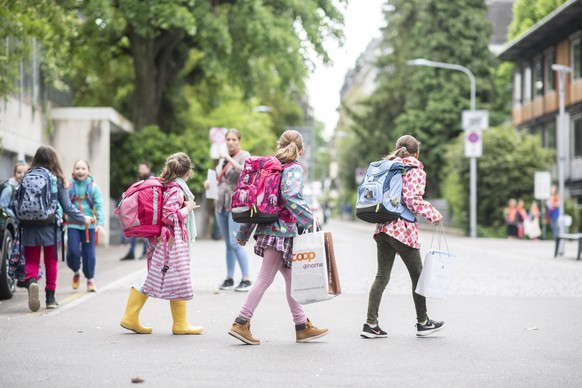 epa08413923 Schoolgirls walk on the first day of school after the public shutdown because of the coronavirus pandemic, at the Hutten schoolhouse in Zurich, Switzerland, 11 May 2020. Switzerland is one ...