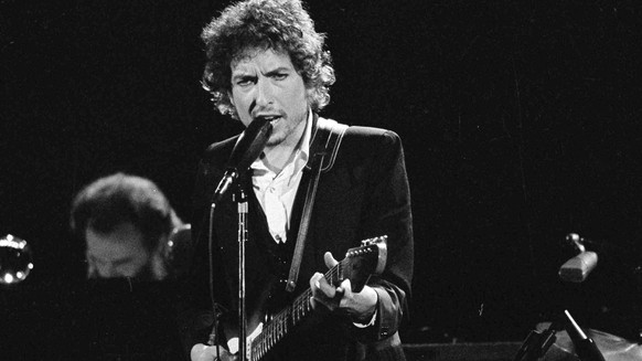 FILE - Musician Bob Dylan performs with The Band at the Forum in Los Angeles on Feb. 15, 1974. Dylan