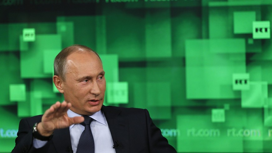 Russian President Vladimir Putin speaks during his visit to the new headquarters of &quot;Russia Today&quot; TV channel in Moscow, Russia, Tuesday, June 11, 2013. (AP Photo/Yuri Kochetkov, Pool)