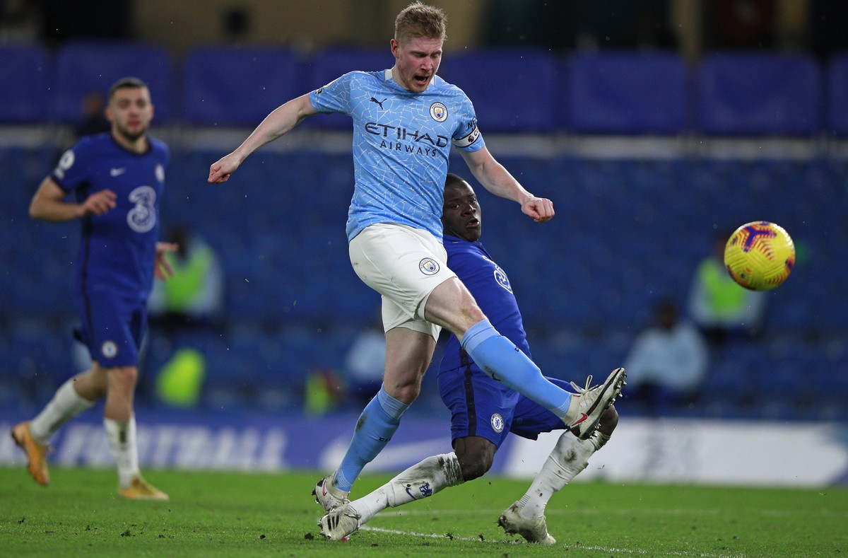 Manchester City's Kevin De Bruyne is challenged by Chelsea's N'Golo Kante during the English Premier League soccer match between Chelsea and Manchester City at Stamford Bridge, London,  ...