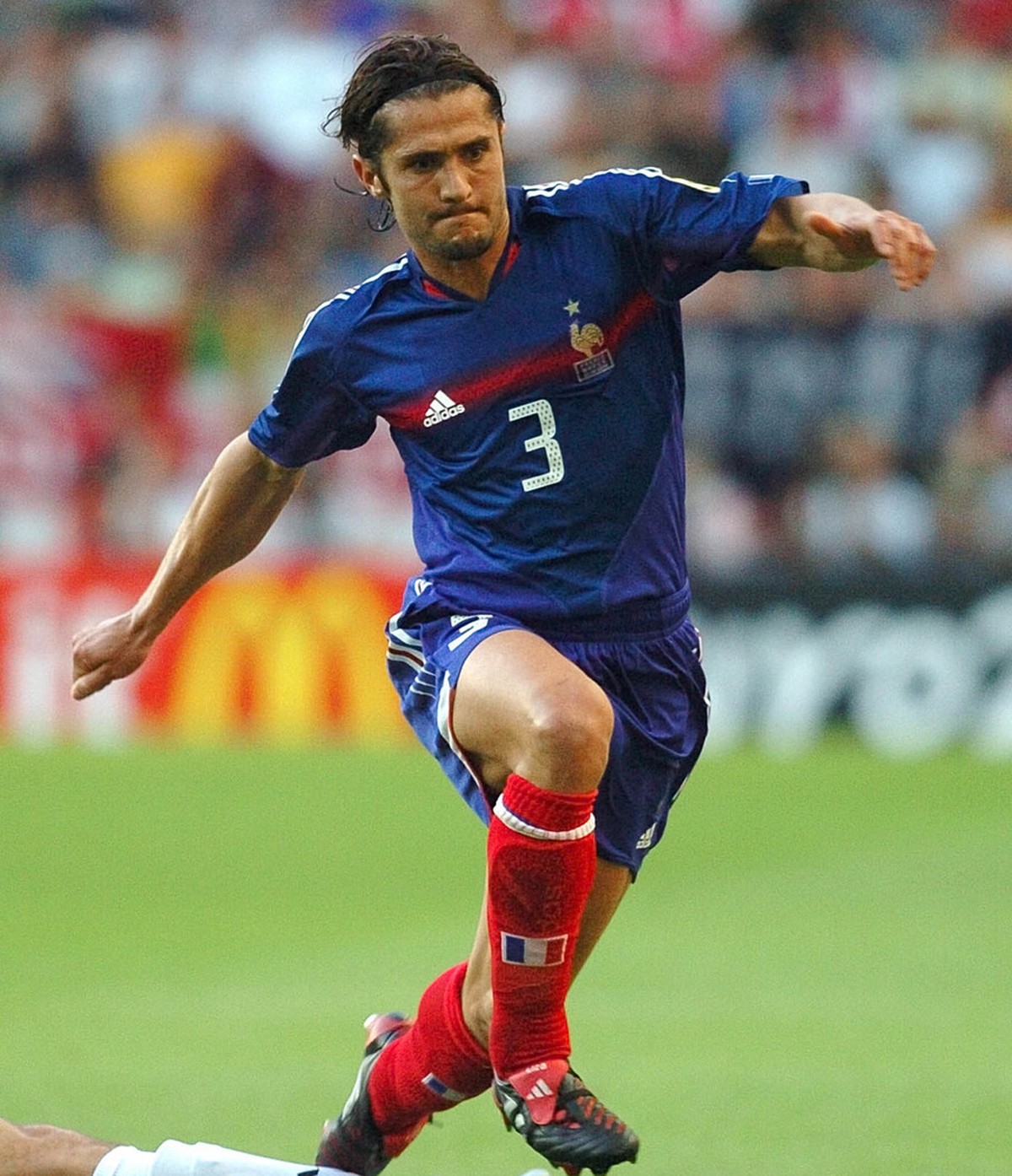 Bixente Lizarazu of France evades a tackle during the Euro 2004 quarter final soccer match between France and Greece at the Jose Alvalade stadium in Lisbon, Portugal, Friday, June 25, 2004. (AP Photo/ ...
