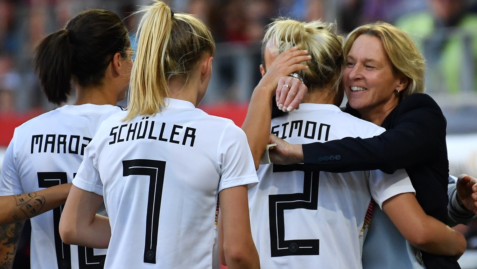 epa07613042 Germany&#039;s Carolin Simon (2-R) and Germany&#039;s head coach Martina Voss-Tecklenburg celebrate the 2-0 lead during the Women&#039;s international soccer friendly match between Germany ...