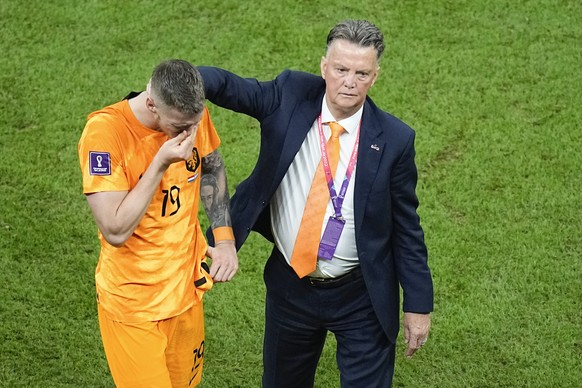 Wout Weghorst, left, is consoled by head coach Louis van Gaal of the Netherlands, at the end of the World Cup quarterfinal soccer match between the Netherlands and Argentina, at the Lusail Stadium in  ...