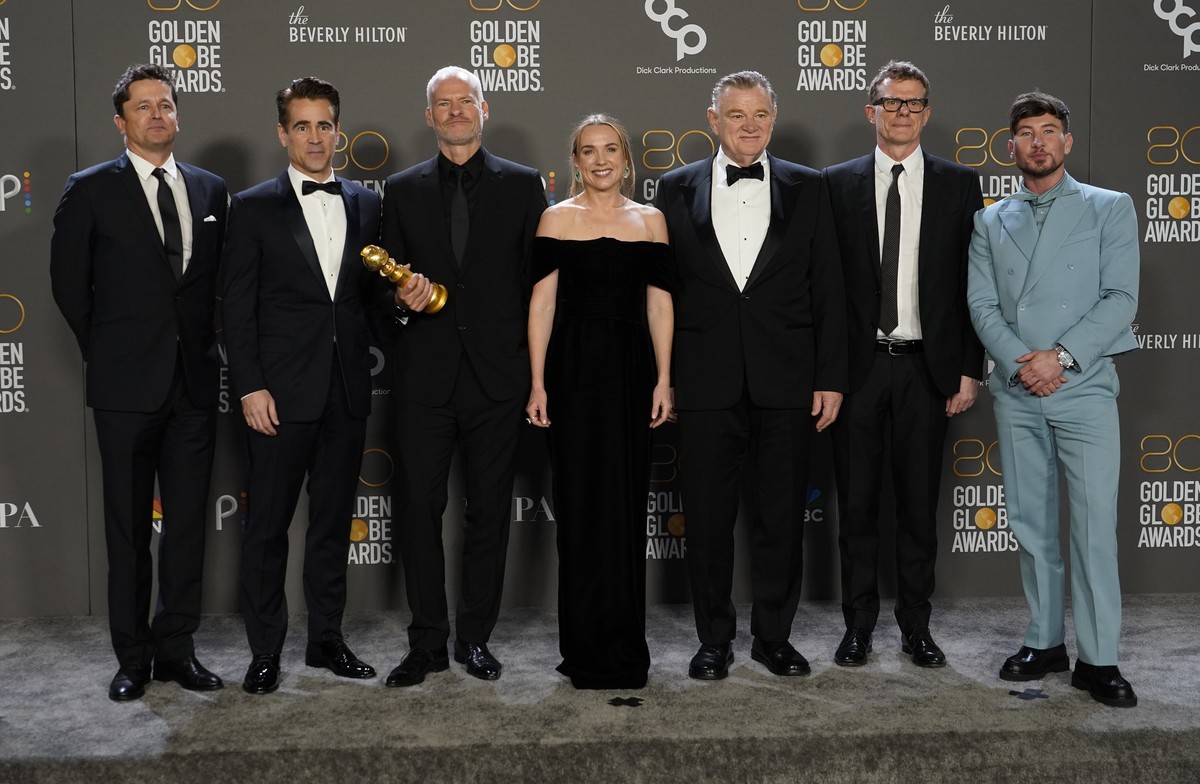 Peter Czernin, from left, Colin Farrell, Martin McDonagh, Kerry Condon, Brendan Gleeson, Graham Broadbent and Barry Keoghan pose in the press room with the award for best motion picture, musical or co ...
