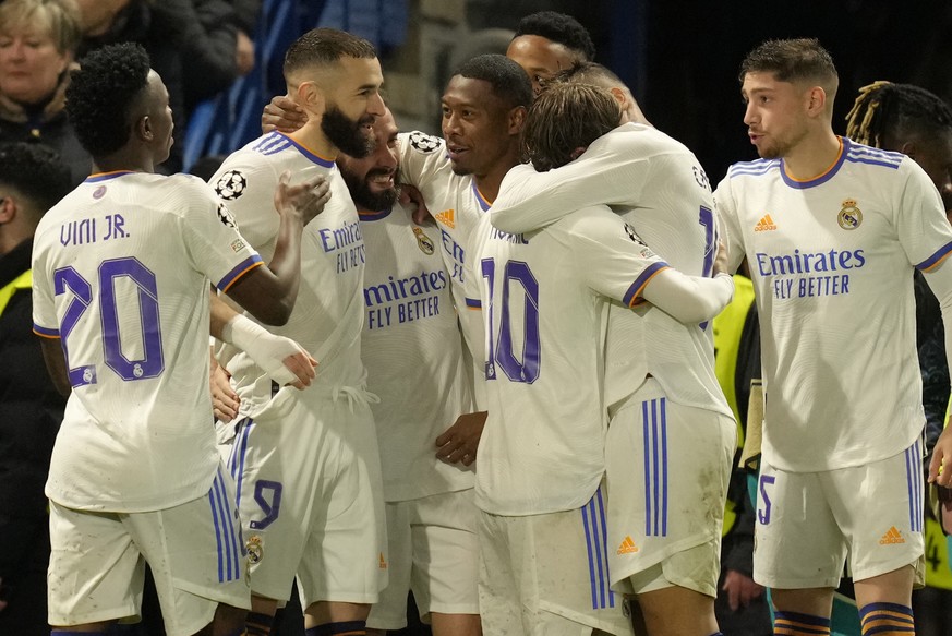 Real Madrid&#039;s Karim Benzema, second from left, celebrates with his teammates after scoring his side&#039;s third goal during a Champions League first-leg quarterfinal soccer match between Chelsea ...