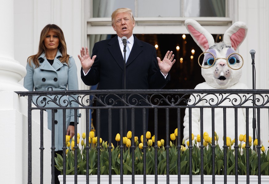 President Donald Trump, joined by the Easter Bunny and first lady Melania Trump, speaks from the Truman Balcony of the White House in Washington, Monday, April 2, 2018, during the annual White House E ...