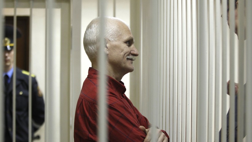 FILE- Ales Bialiatski, the jailed leader of Vesna, the most prominent human rights group in Belarus, stands in a cage during a court session in Minsk, Belarus, Thursday, Nov. 24, 2011. On Friday, Oct. ...