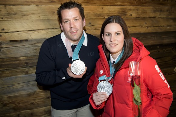 Martin Rios, left, and Jenny Perret, right, of Switzerland pose with their silver medals at the House of Switzerland after the victory ceremony of the curling mixed doubles at the XXIII Winter Olympic ...