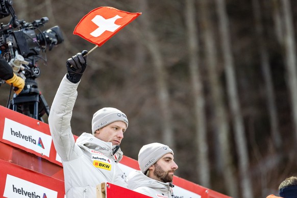 Marvin Scherrer, coach skijumping Swiss-Ski, right, looks on as Rune Velta, head coach mens skijumping Swiss-ski, gives the start sign during the men&#039;s FIS Ski Jumping World Cup competition at th ...