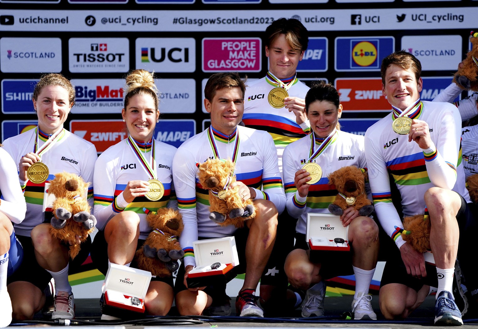 Switzerland&#039;s Stefan Bissegger, Stefan Kung, Mauro Schmid, Elise Chabbey, Nicole Koller and Marlen Reusser celebrate on the podium after winning gold in the Team Time Trial Mixed Relay race on da ...