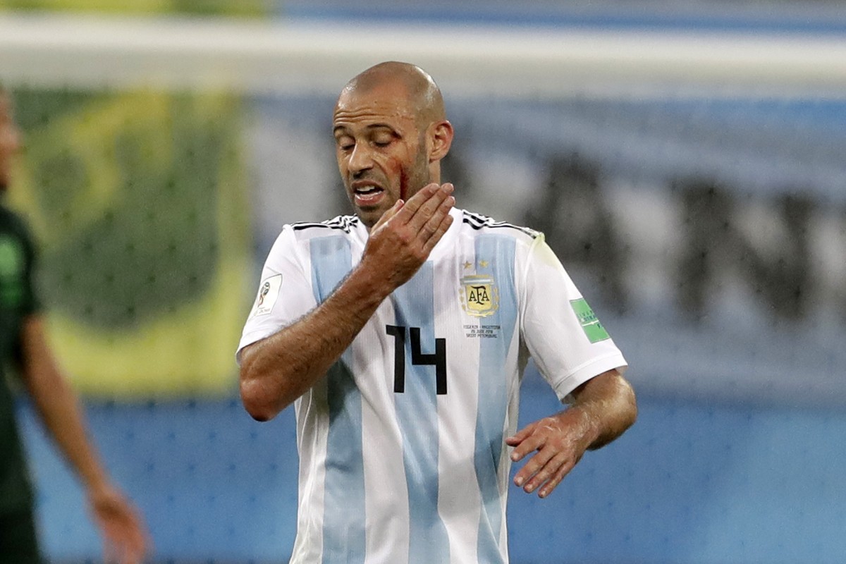 Argentina's Javier Mascherano touches his face after an injuring during the group D match between Argentina and Nigeria, at the 2018 soccer World Cup in the St. Petersburg Stadium in St. Petersbu ...