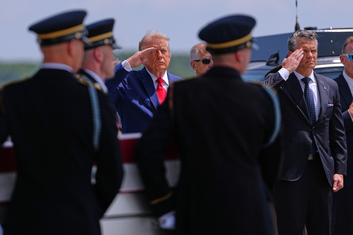 President Donald Trump and Secretary of Defense Pete Hegseth salute as a U.S. Army carry team moves a transfer case containing the remains of Sgt. Angel S. Rampersad, of Ozone Park, N.Y. Wednesday, Ju ...
