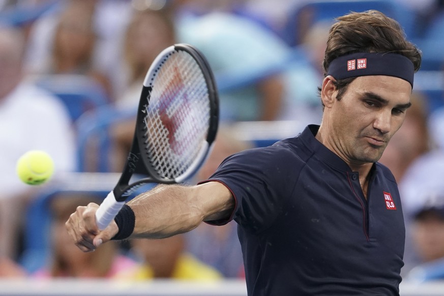 Roger Federer, of Switzerland, returns to David Goffin, of Belgium, during the semifinals at the Western &amp; Southern Open tennis tournament, Saturday, Aug. 18, 2018, in Mason, Ohio. (AP Photo/John  ...