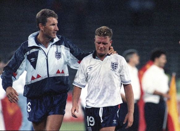 FILE - The July 4, 1990 file photo shows England&#039;s Paul Gascoigne crying as he is escorted off the field by team captain Terry Butcher, after his England lost a penalty shoot-out in the semi-fina ...