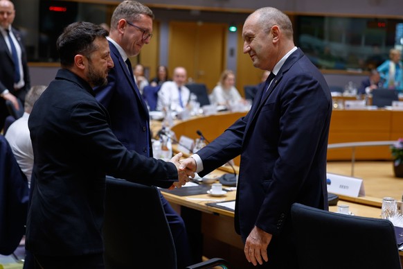 Ukraine's President Volodymyr Zelenskyy, left, greets Bulgaria's Prime Minister Rumen Radev during a round table meeting at the EU summit in Brussels, Thursday, June 18, 2026. (AP Photo/Geer ...