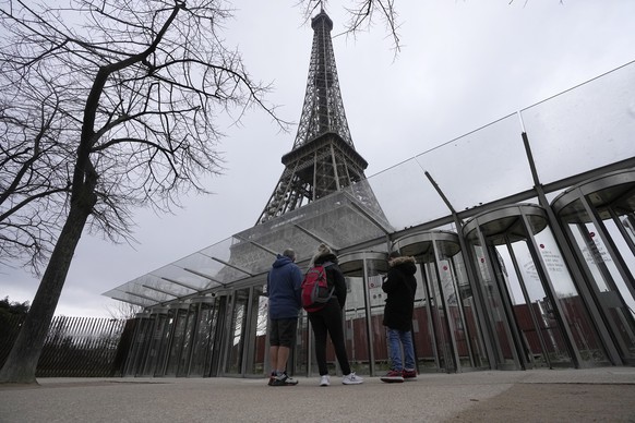 Visitors stand at the closed gates leading to the Eiffel Tower, Tuesday, Feb. 20, 2024 in Paris. Visitors to the Eiffel Tower were turned away for the second consecutive day because of a strike over p ...