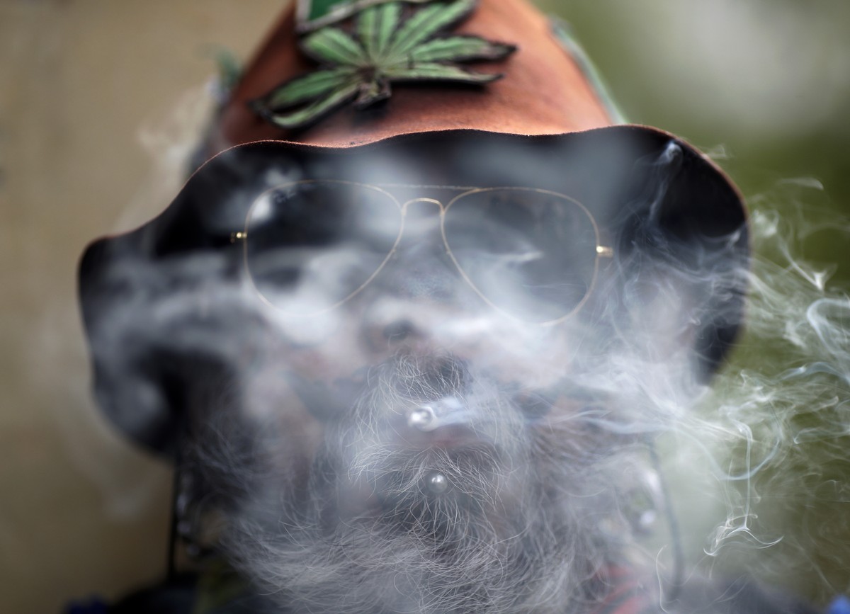 epaselect epa09898626 A man smokes a joint as people take part in a parade to mark the so-called 420 World Cannabis Day in Bangkok, Thailand, 20 April 2022. The annual 420 or 4/20 is known in cannabis ...