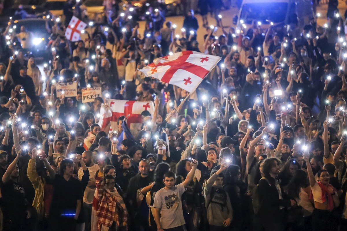 Demonstrators wave Georgian national flags during an opposition protest against "the Russian law" in the center of Tbilisi, Georgia, on Thursday, May 2, 2024. The parliament of Georgia has c ...