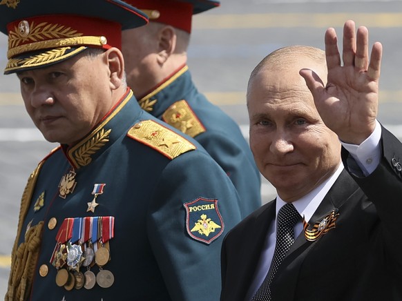 FILE - Russian President Vladimir Putin, right, and, Defense Minister Sergei Shoigu leave Red Square after the Victory Day military parade marking the 75th anniversary of the Nazi defeat in Moscow, Ru ...