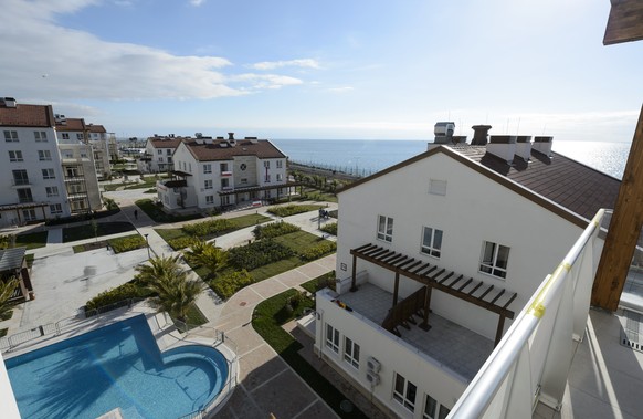 The view on a swimmingpool and the Black Sea from a balcony of the house of the Swiss team is pictured during a press visit of the Coastal Cluster Olympic Village at the XXII Winter Olympics 2014 Soch ...