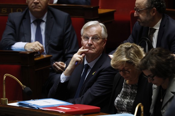 epa11649529 French Prime Minister Michel Barnier listens to speeches as the French government faces a no-confidence vote session at the National Assembly in Paris, France, 08 October 2024. EPA/YOAN VA ...