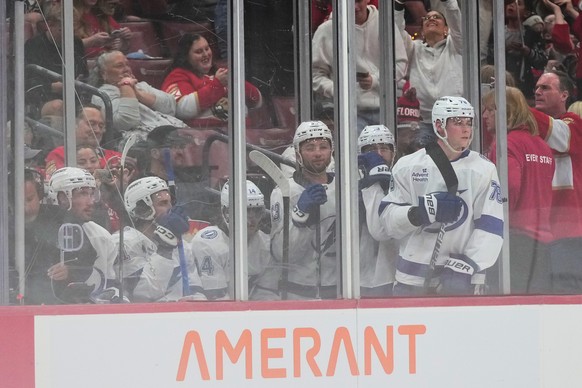 Tampa Bay Lightning players look from the penalty box during the second period of an NHL hockey preseason game against the Florida Panthers, Saturday, Oct. 4, 2025, in Sunrise, Fla. (AP Photo/Lynne Sl ...