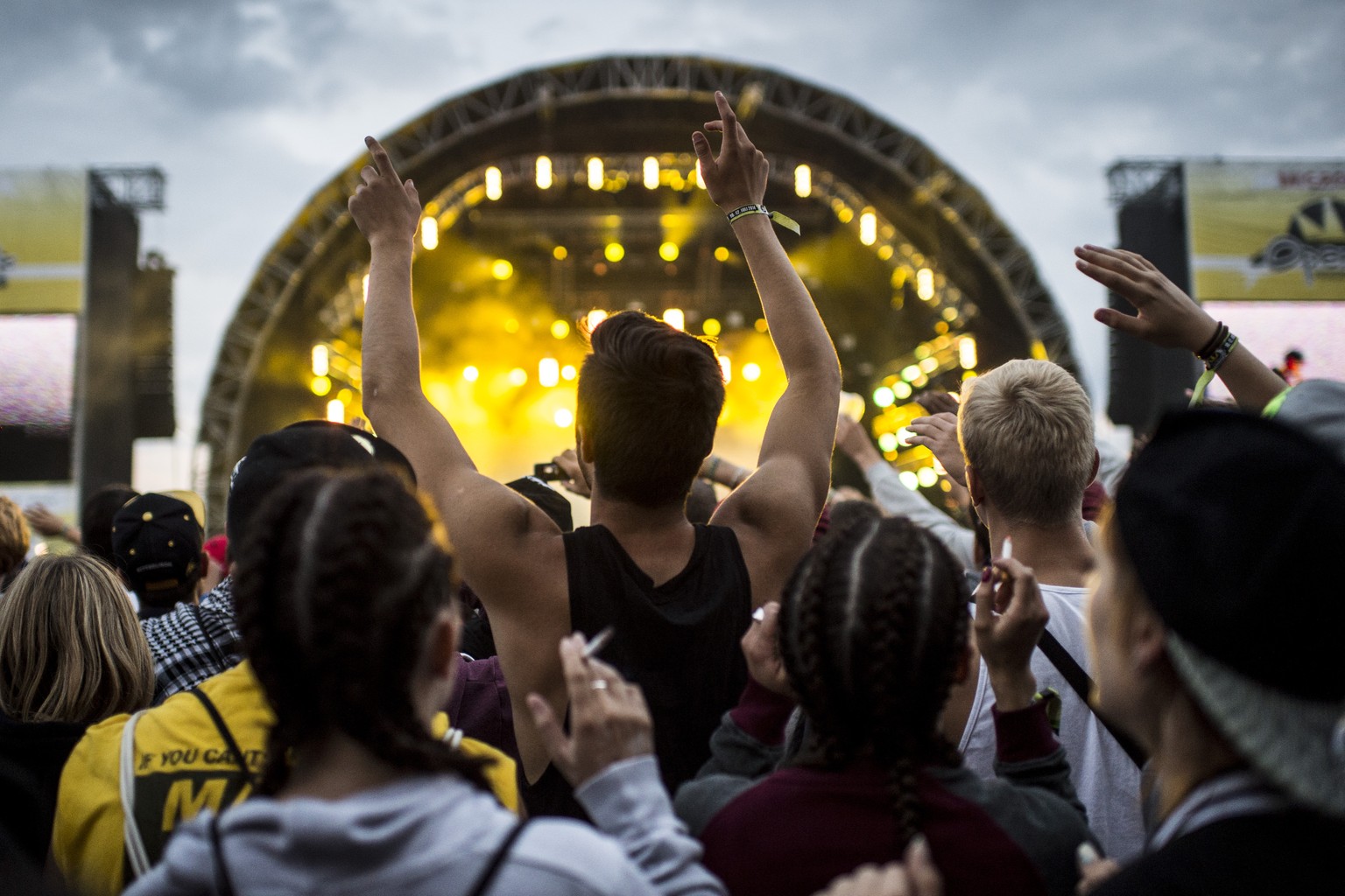 Festival-goers enjoy the performance of American rapper Cameron Jibril Thomaz, aka Wiz Khalifa, during the Openair Frauenfeld music festival in Frauenfeld, Switzerland, on Friday, July 11, 2014. The 2 ...