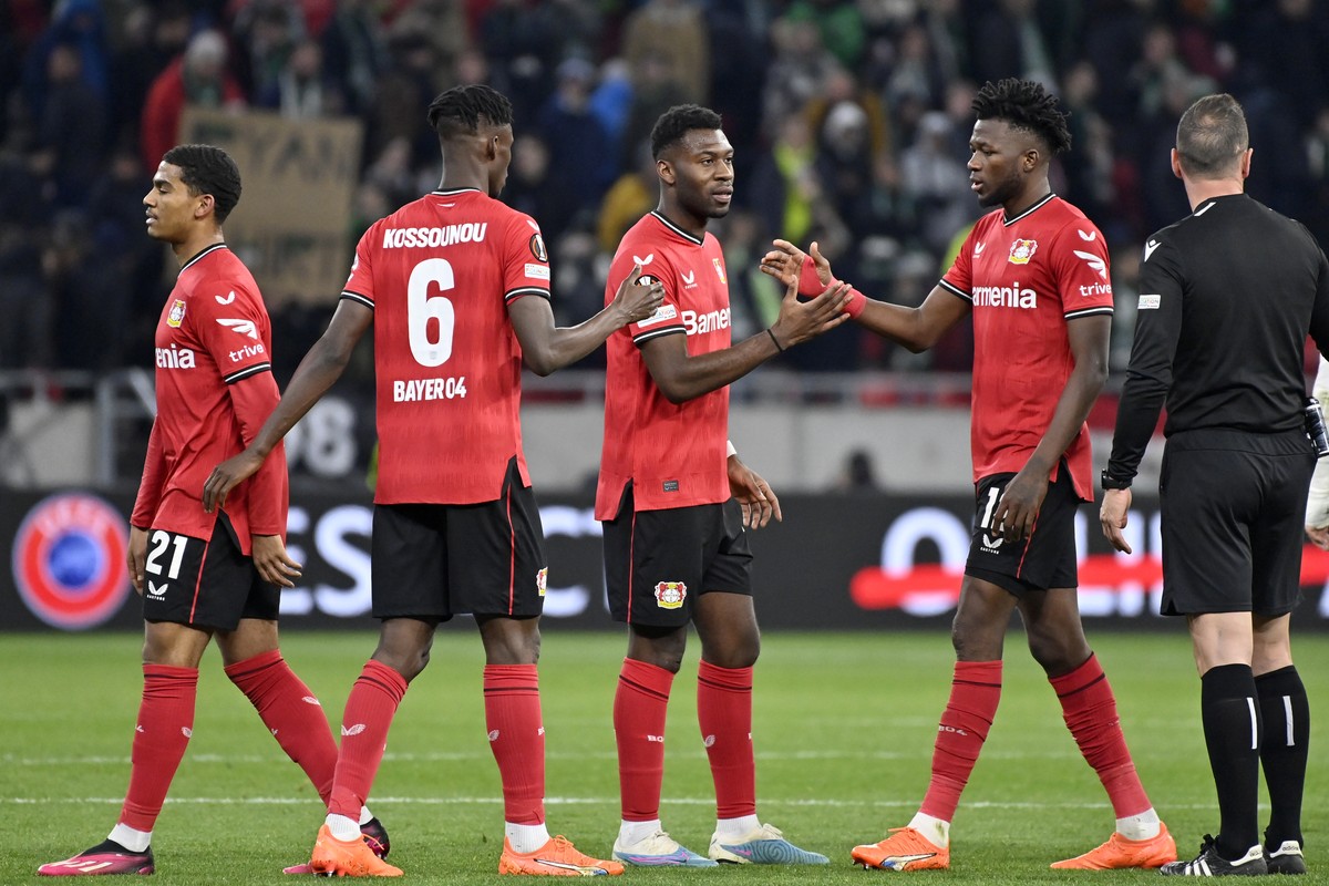 Leverkusen players shake hands at the end of the Europa League round of 16, 2nd leg, soccer match between Ferencvaros and Bayer 04 Leverkusen at the Puskas Arena in Budapest, Thursday, March 16, 2023. ...