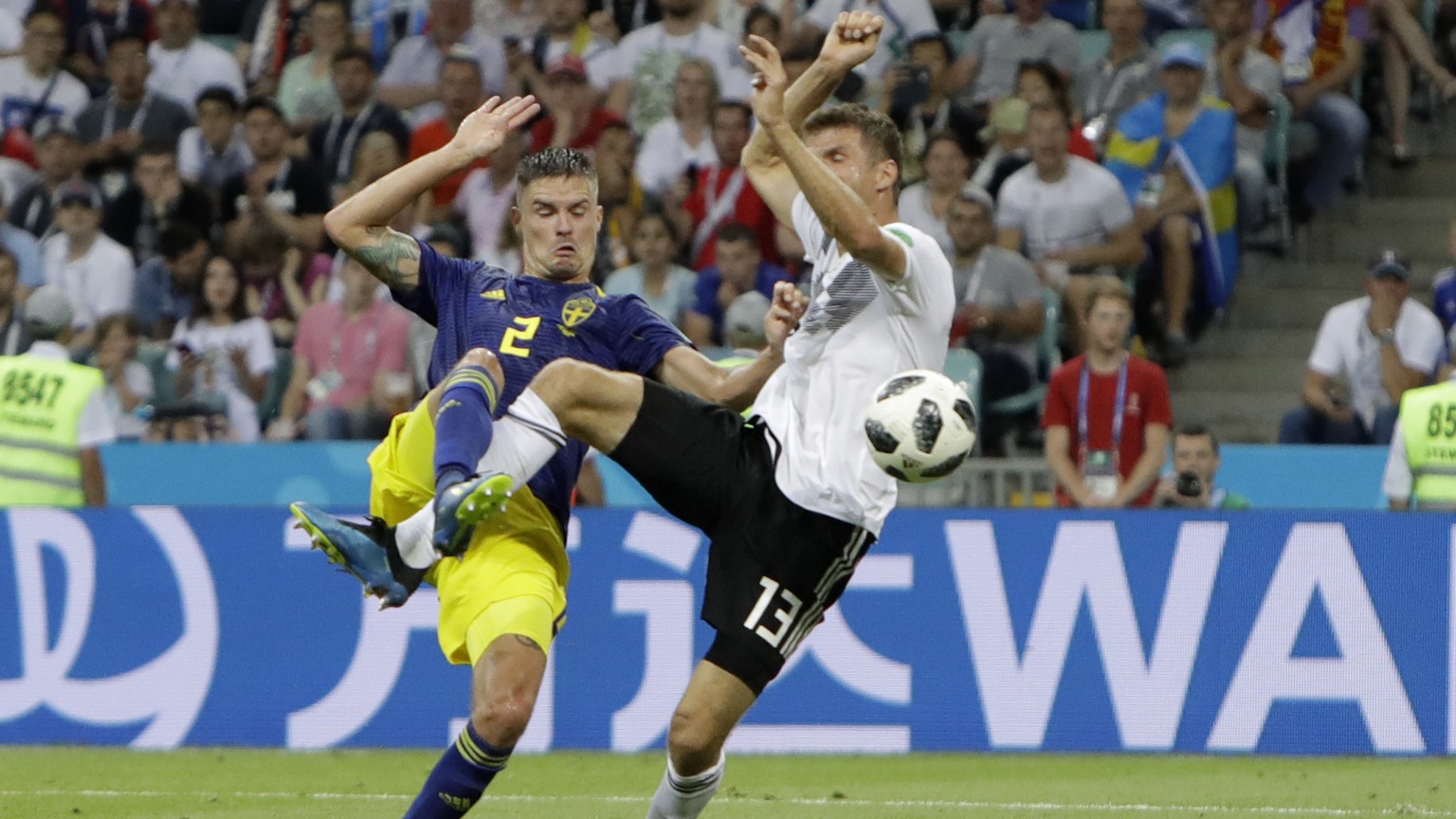 Germany&#039;s Thomas Mueller makes contact with Sweden&#039;s Mikael Lustig, left, during the group F match between Germany and Sweden at the 2018 soccer World Cup in the Fisht Stadium in Sochi, Russ ...