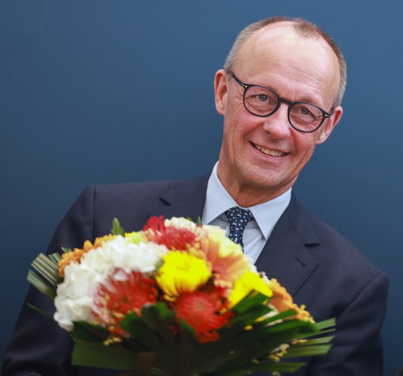 epa11920803 Chairman of Germany&#039;s Christian Democratic Union (CDU) Friedrich Merz receives flowers prior a party leadership meeting of the Christian Democratic Union (CDU) at the party&#039;s hea ...