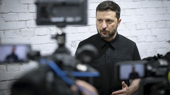 epa12261862 A handout picture made available by the Presidential Press Service shows Ukraine's President Volodymyr Zelensky visiting a facility where interceptor drones are produced at an undiscl ...