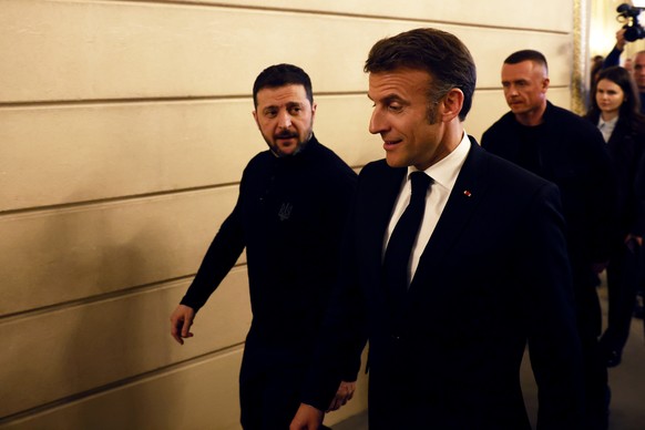 epa11990253 French President Emmanuel Macron (R) and Ukrainian President Volodymyr Zelensky (L) leave a press conference following a bilateral meeting at the Elysee Palace in Paris, France, 26 March 2 ...