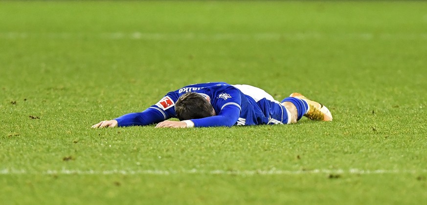 FILE - In this Dec. 16, 2020 file photo, Schalke&#039;s Benito Raman lies on the ground during the German Bundesliga soccer match between FC Schalke 04 and SC Freiburg at the Arena in Gelsenkirchen, G ...