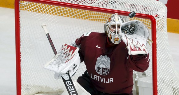 epa09225237 Goalkeeper of Latvia, Ivars Punnenovs, in action during the IIHF 2021 World Ice Hockey Championships group B match between Latvia and Italy at the Arena Riga, Latvia, 24 May 2021. EPA/TOMS ...