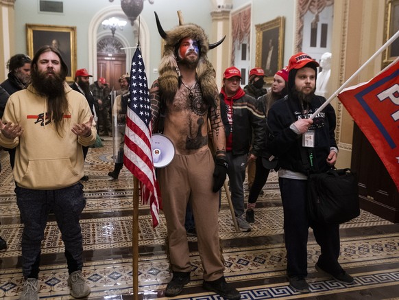 epa09664285 (14/24) (FILE) - Supporters of US President Trump stand by the door to the Senate chambers after they breached the US Capitol security in Washington, DC, USA, 06 January 2021 (reissued 03  ...