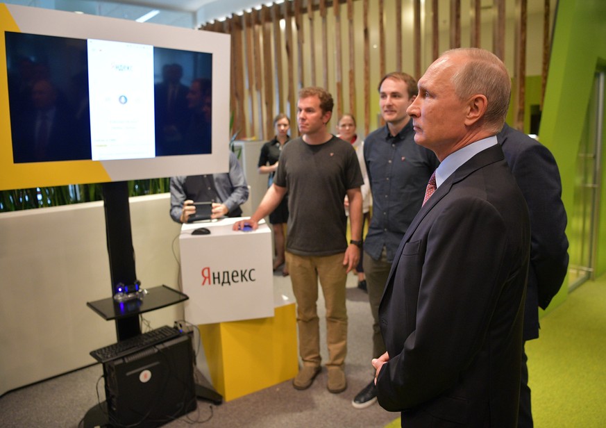 epa06217738 President Vladimir Putin (R) attends a demonstration of the prototype of an unmanned car during his visit at Moscow office of the IT company Yandex in Moscow, Russia, 21 September 2017. EP ...