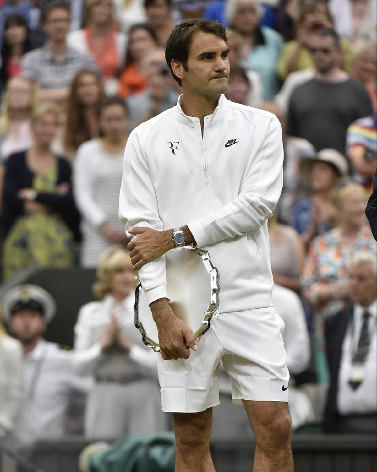 Roger Federer of Switzerland holds the runner up trophy up after being defeated by Novak Djokovic of Serbia in the men's singles final at the All England Lawn Tennis Championships in Wimbledon, L ...