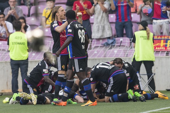 Basels players with Basel&#039;s defender Michael Lang, center, celebrate their first goal during the Swiss Cup final soccer match between FC Basel 1893 and FC Sion at the stade de Geneve stadium, in  ...