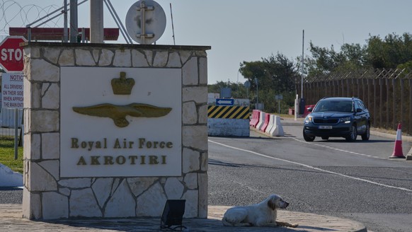 A dog sits at the main gate of the U.K.s RAF Akrotiri air base after it was hit by a drone strike early morning near Limassol, Cyprus, Monday, March, 2, 2026. (AP Photo/Petros Karadjias)
Cyprus Iran  ...