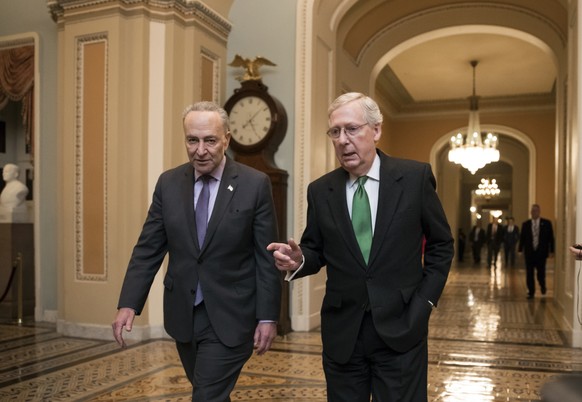 Senate Majority Leader Mitch McConnell, R-Ky., and Senate Minority Leader Chuck Schumer, D-N.Y., left, walk to the chamber after collaborating on an agreement in the Senate on a two-year, almost $400  ...
