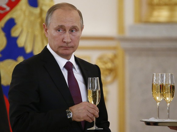 In this Nov. 9, 2016, photo, Russian President Vladimir Putin makes a toast during a ceremony for receiving diplomatic credentials from foreign ambassadors in the Kremlin in Moscow, Russia. In careful ...