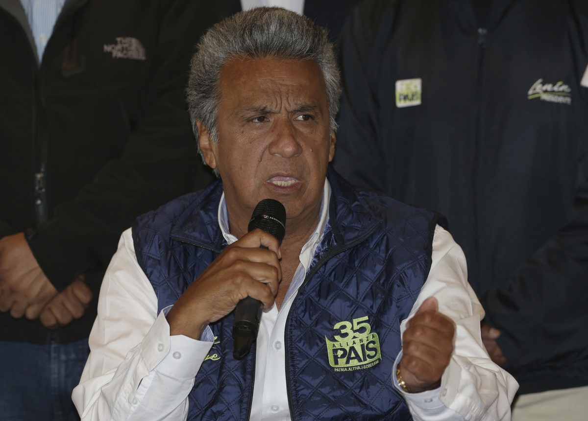 Lenin Moreno, presidential candidate for the ruling party Alliance PAIS, center, speaks during a news conference where he said, "no to violence" as Ecuadoreans wait for results of the presid ...
