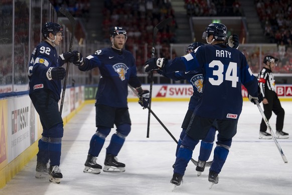 epa13000818 Finland's Lenni Hameenaho (L) celebrates with his teammates Nikolas Matinpalo and Aatu Raty (R) after scoring the 4-1 goal during the 2026 IIHF Men's Ice Hockey World Championshi ...