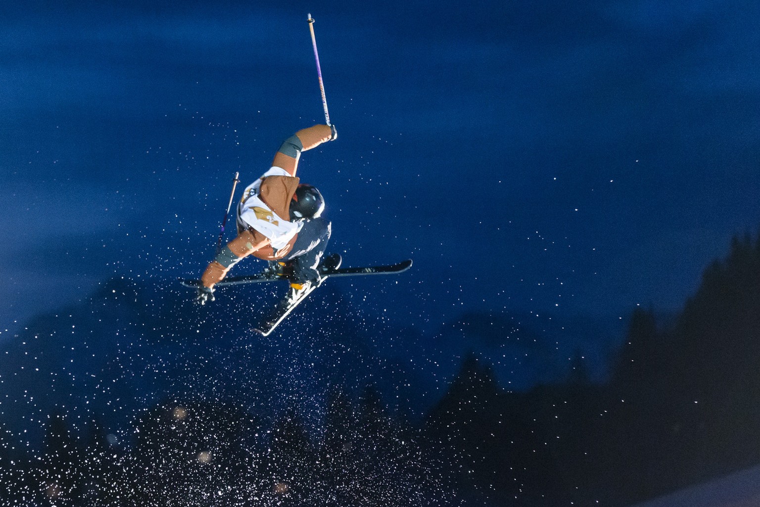 A rider leaps over the river Vieze during the 2nd edition of the 7Peaks Riverstyle in Morgins, Switzerland Friday, March 31, 2017. The 7Peaks Riverstyle is a freestyle ski competition in the Swiss apl ...