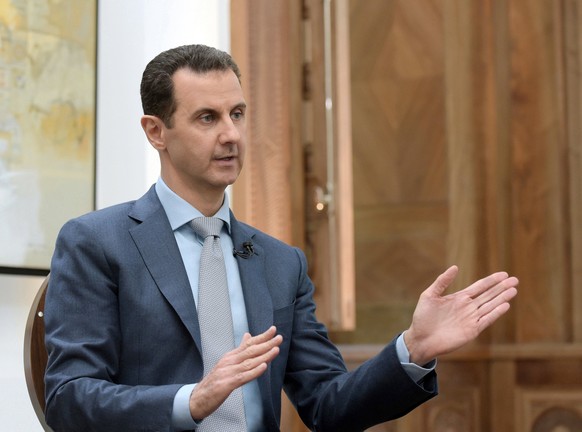 epa05782771 A handout photo made available by the Syrian Arab News Agency (SANA) on 10 February 2017 shows Syrian President Bashar al-Assad speaking during an interview to Yahoo News in Damascus, Syri ...