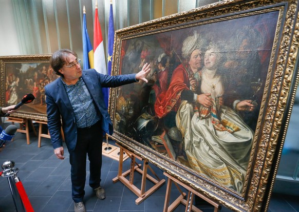 epa05542499 Ad Geerdink, Director Westfries Museum, shows some elements of painting during the handing ceremony of five paintings to the Dutch Westfries Museum, in Kiev, Ukraine, 16 September 2016. A  ...